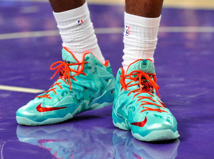 View of green and red Nike LeBron shoes.